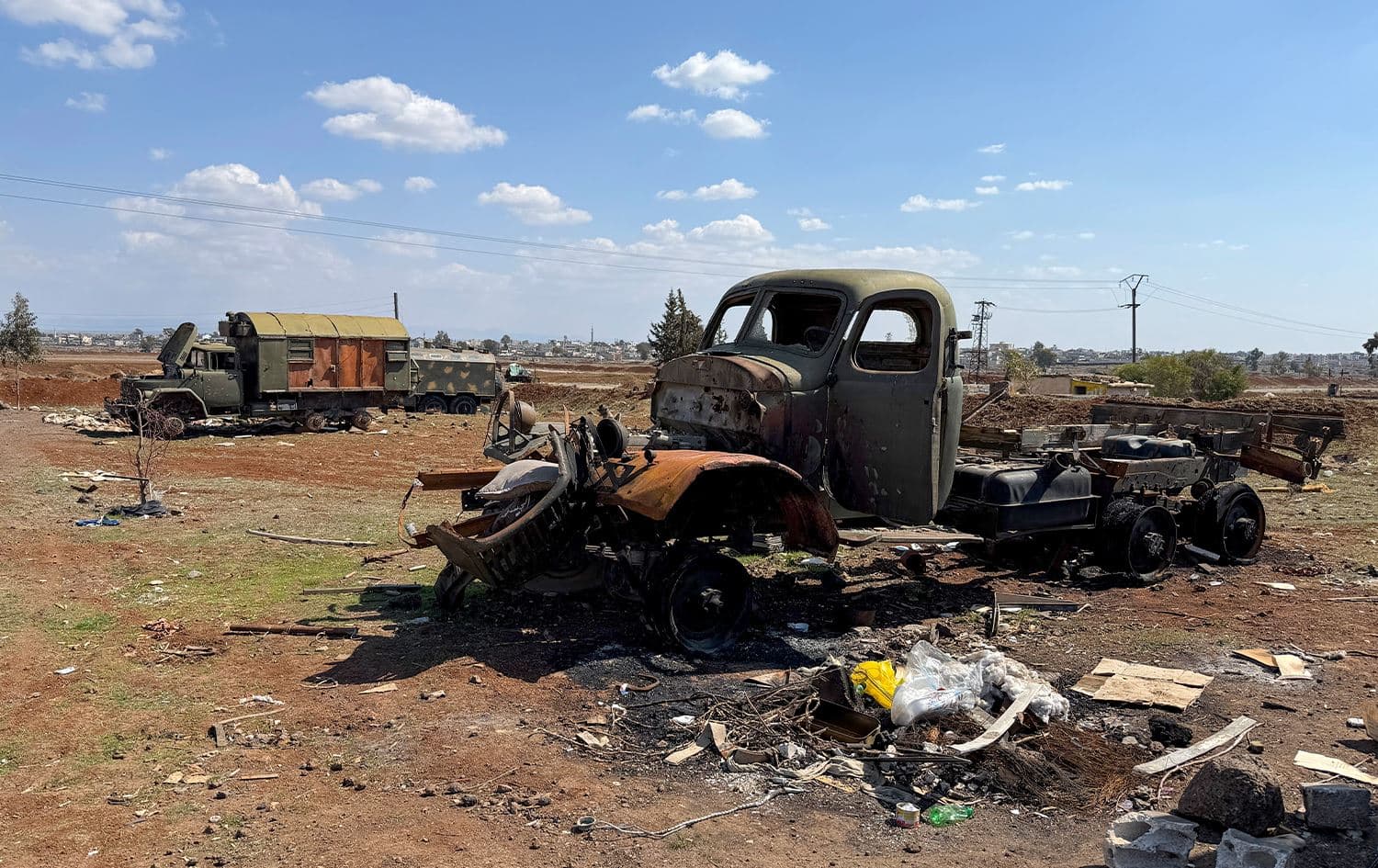 The wreckage of vehicles sit in a field in Syria's southern province of Daraa, on March 11, 2025, following an Israeli military strike. Photo: Sam Hariri/AFP