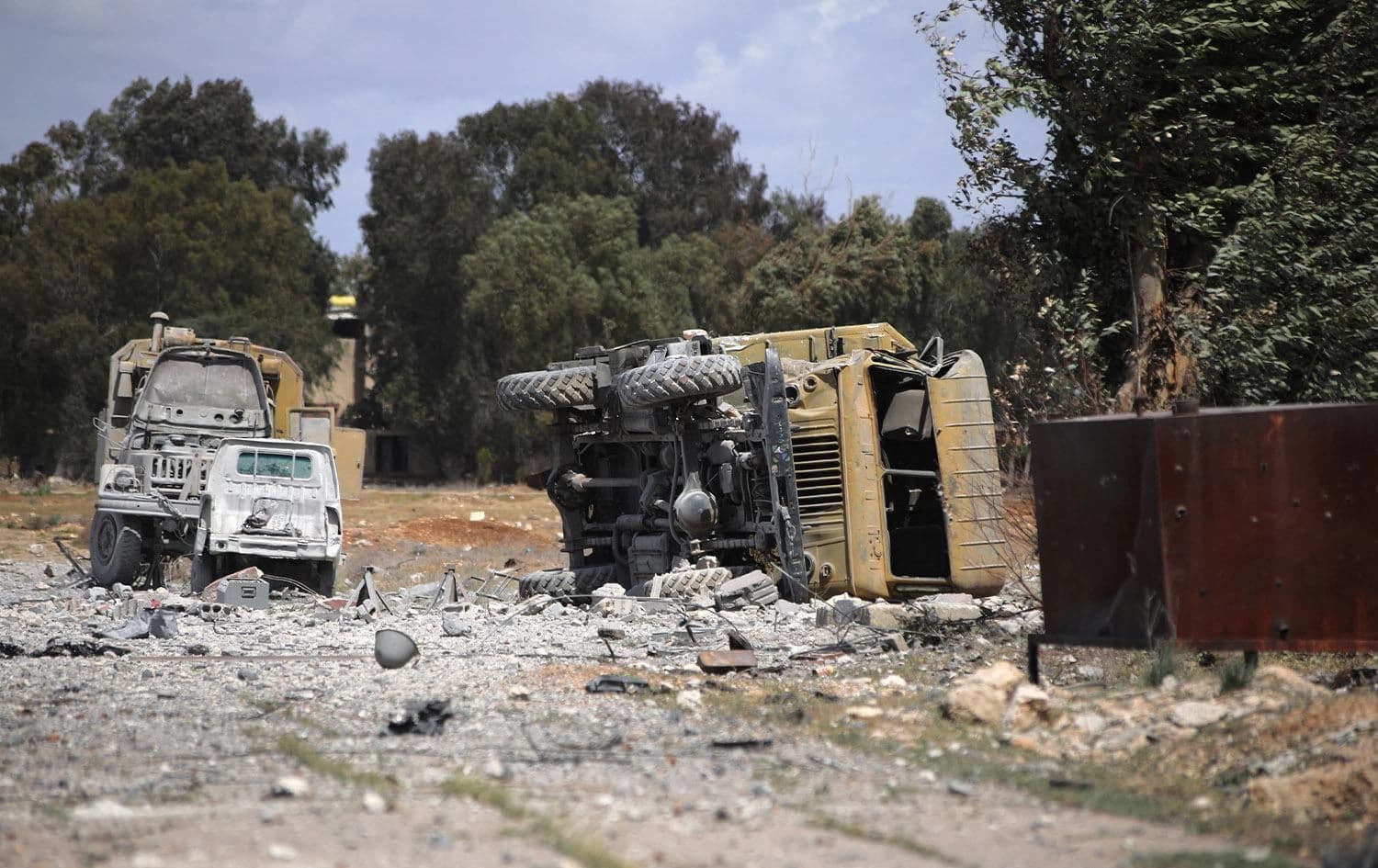 Debris and military vehicles lie at the scene of an Israeli strike in Syria's southern Hama province on April 3, 2025. Photo: AFP