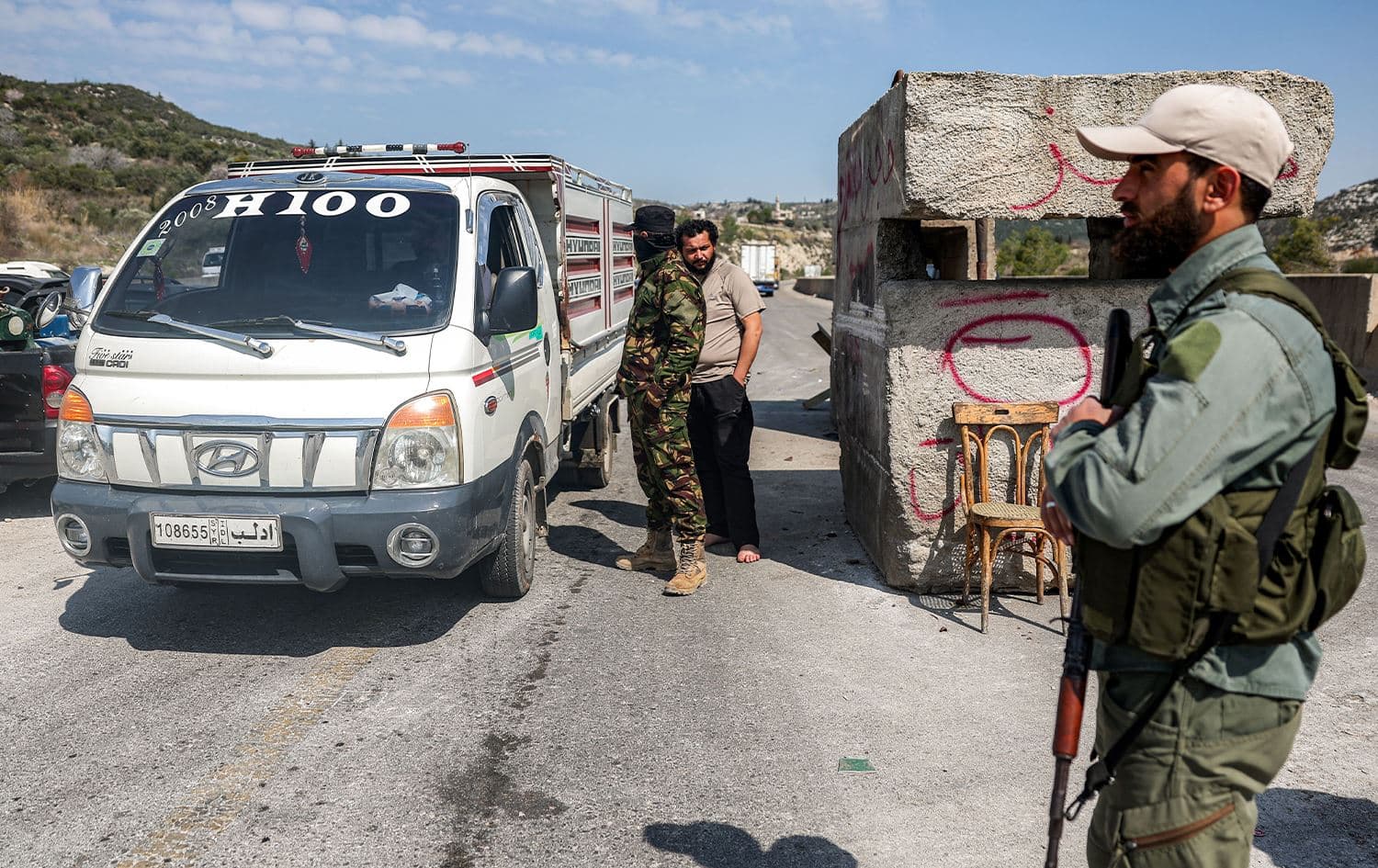 Security forces loyal to the interim Syrian government stop a vehicle for inspection at a checkpoint in Syria's western city of Latakia on March 9, 2025. Photo: AFP