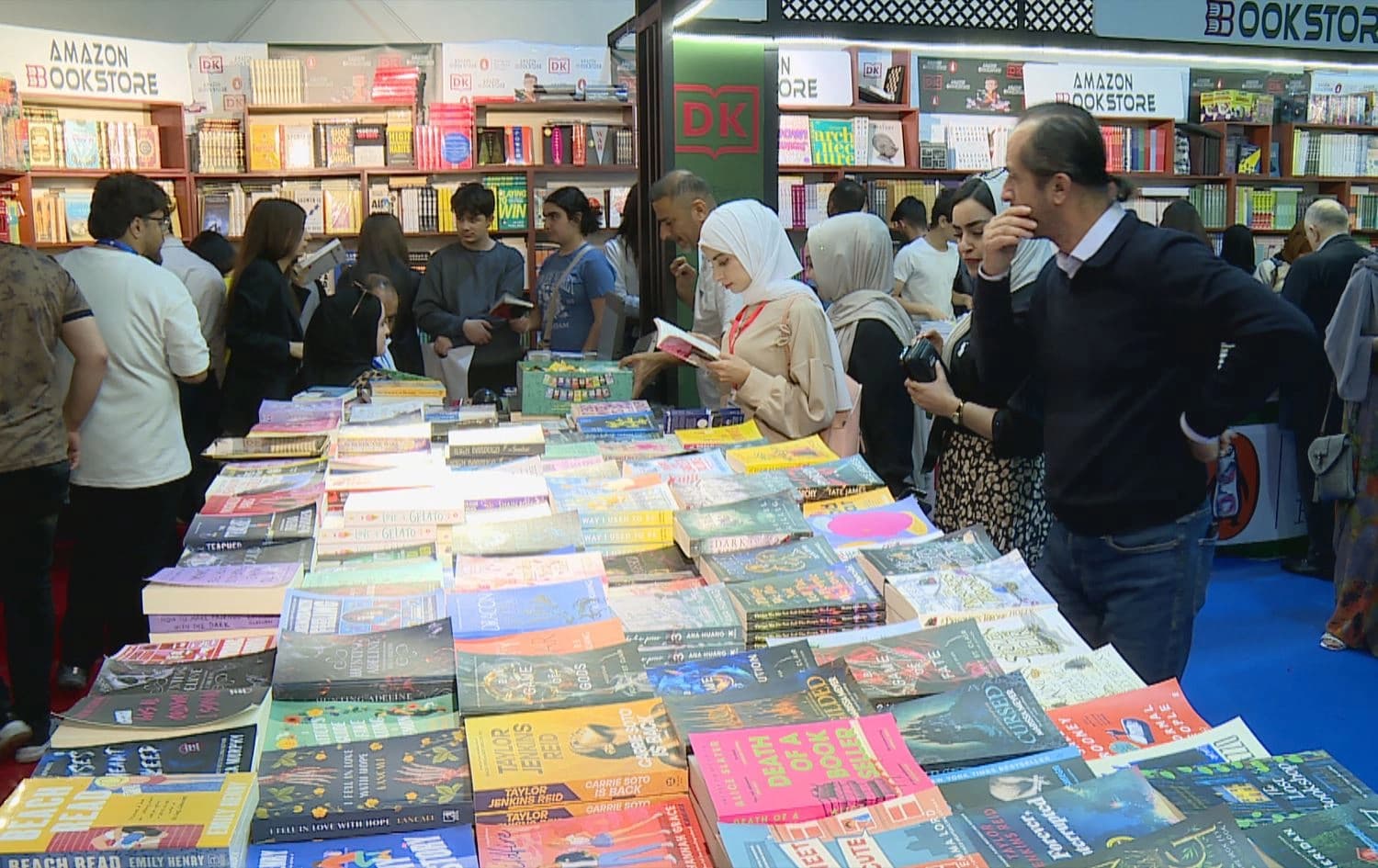 Readers browse through English books at the 17th International Book Fair in Erbil on April 11, 2025. Photo: Rudaw