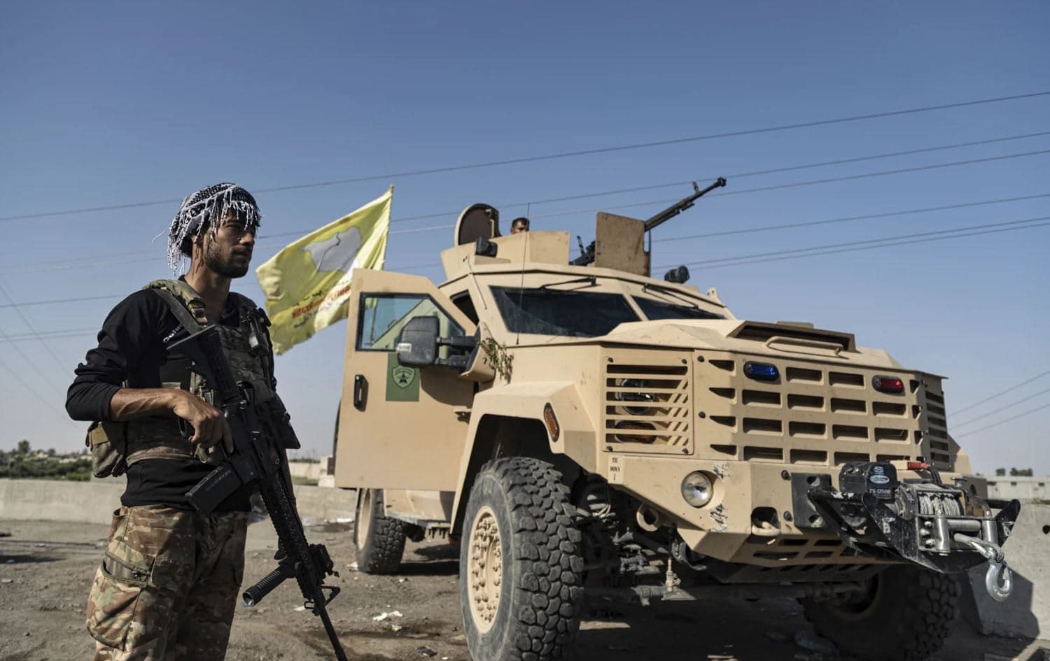 An SDF fighter stands next to an armored vehicle in Deir ez-Zor, eastern Syria in September 2023. Photo: AFP