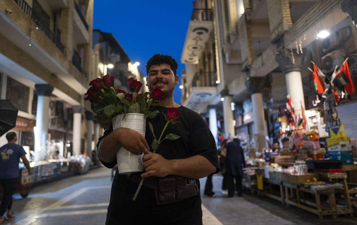 A man selling roses on al-Mutannabi Street in Baghdad on May 2, 2025. Photo: Jewel Samad/ AFP