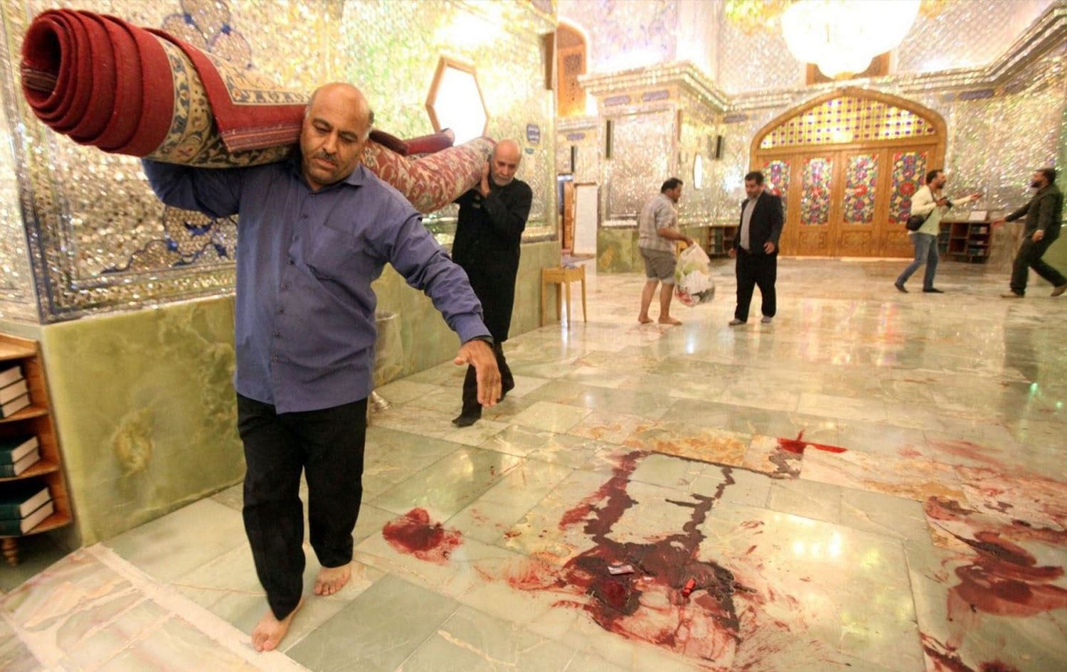 Workers clean after a deadly armed attack at the Shah Cheragh mausoleum in Shiraz, Iran on October 26, 2022. File photo: ISNA/AFP
