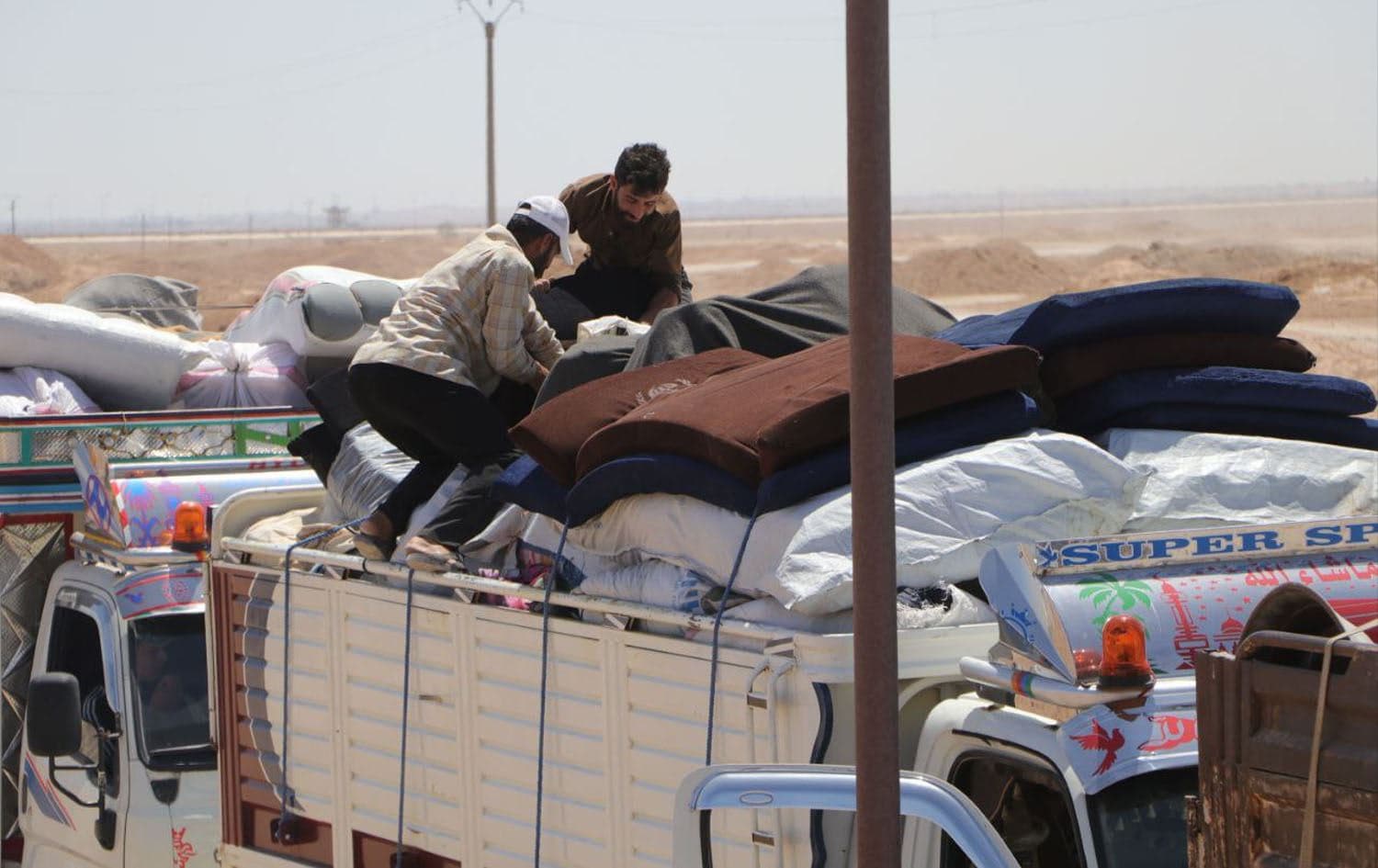 Residents load their belongings onto a truck at Areesha camp in northeast Syria’s Hasaka province on May 29, 2025. Photo: DAANES