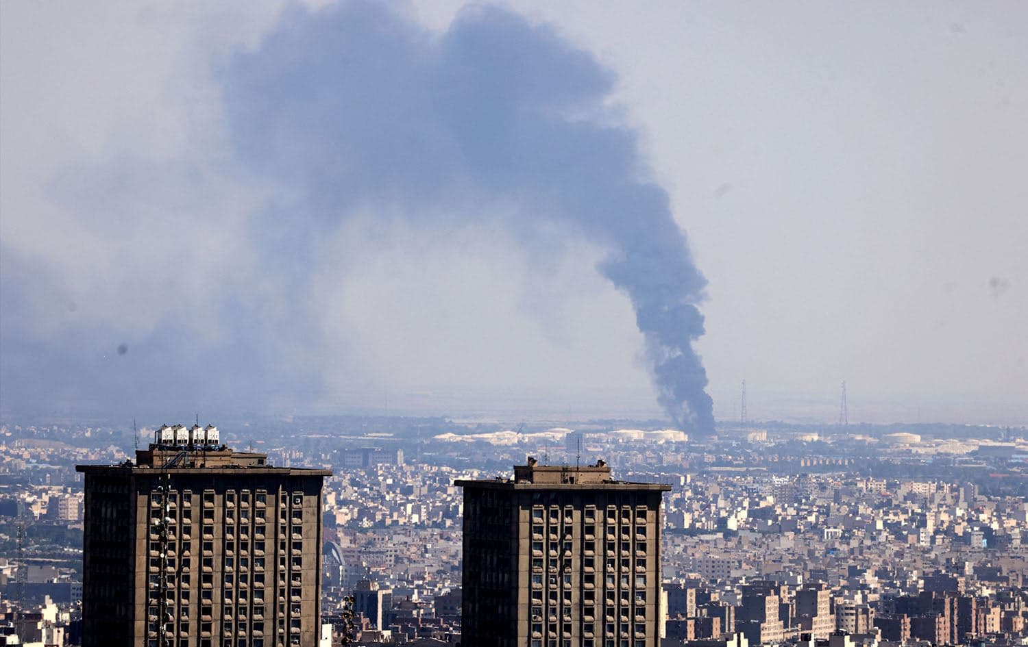 Smoke billows in the distance from an oil refinery following an Israeli strike on the Iranian capital Tehran on June 17, 2025. Photo: Atta Kenare/AFP