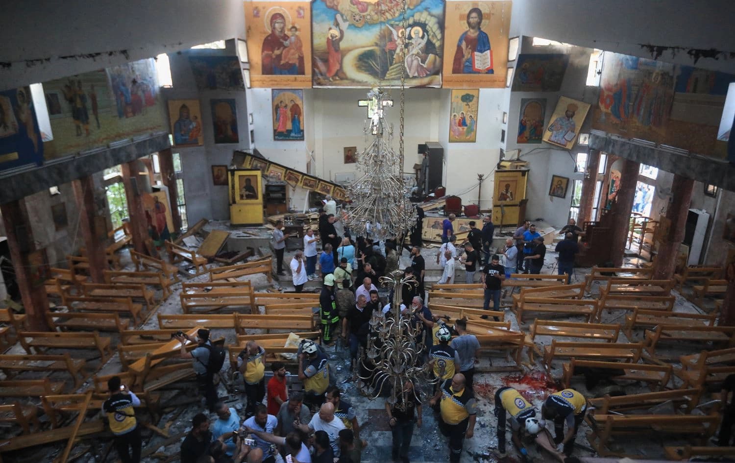 People and rescuers inspect the damage at the site of a reported suicide attack at the Saint Elias church in Damascus' Dwelaa area on June 22, 2025. Photo: AFP