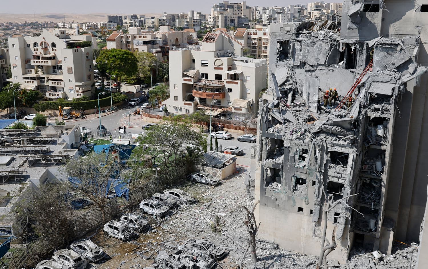 Emergency workers check the damage caused to a building from an Iranian missile strike in Beersheba in southern Israel on June 24, 2025. Photo: AFP
