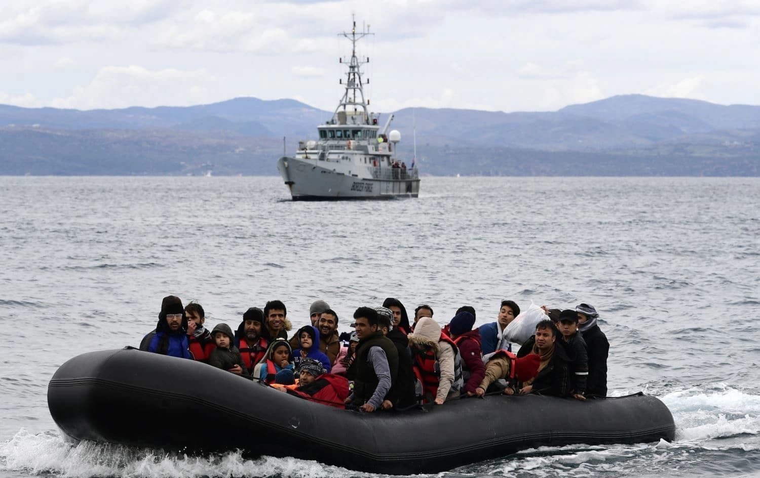 Migrants in a dinghy accompanied by a Frontex vessel on the Greek island of Lesbos, after crossing the Aegean Sea from Turkey on February 28, 2021. Photo: AFP