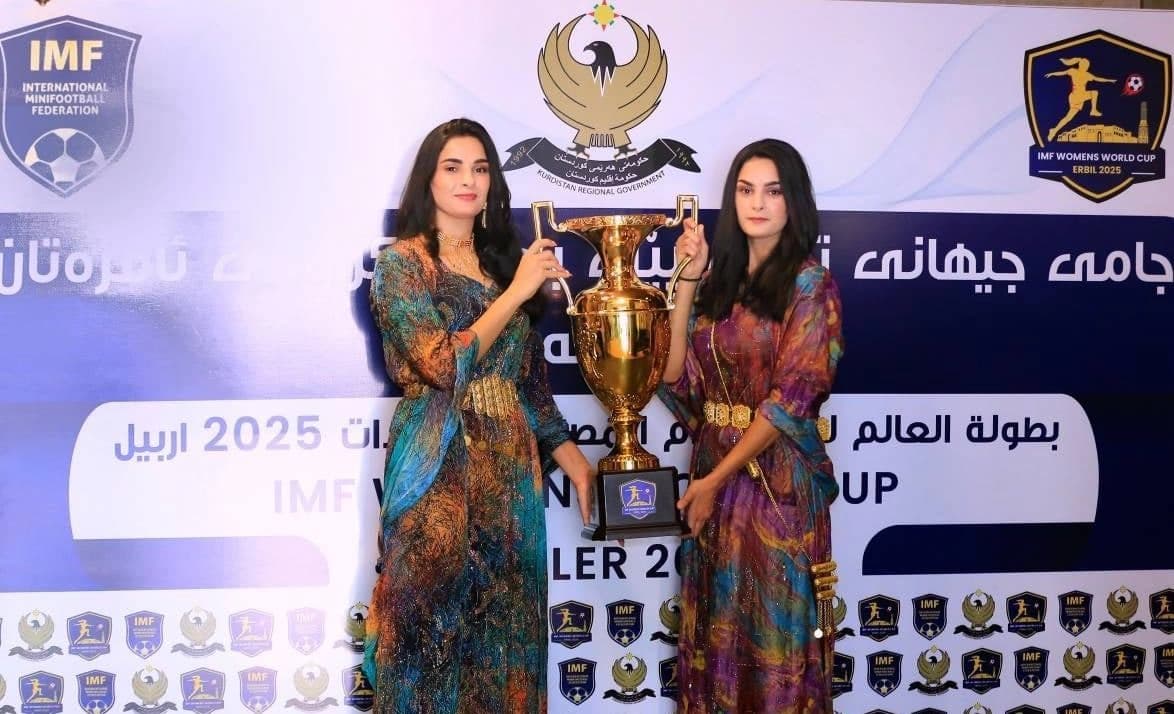 Two women holding a cup in Erbil ahead of women’s minifootball world cup. Photo: Rudaw 