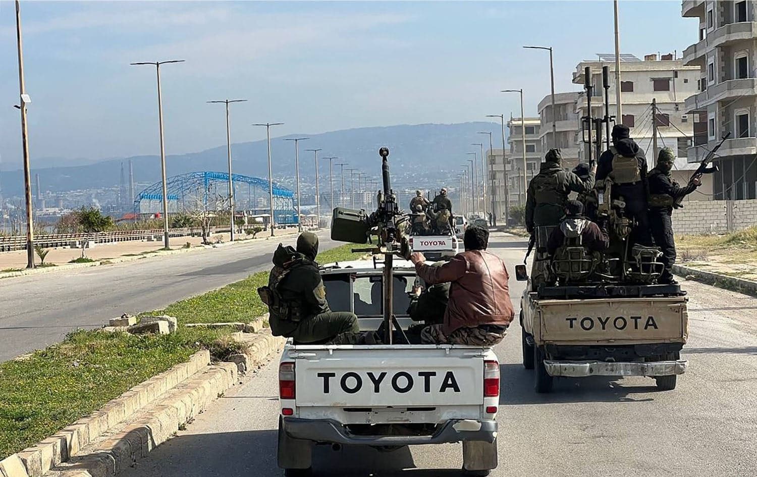Members of the Syrian security forces entering the western city of Baniyas in Tartous province to reinforce government troops in clashes with militants loyal to deposed ruler Bashar al-Assad, on March 7, 2025. Photo: SANA/AFP
