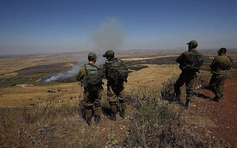 Israeli soldiers at an army base in the Golan Heights look out across the border with Syria. AFP file photo