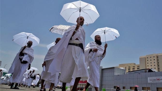 Muslim pilgrims walk, holding their umbrellas at the Mina tent camp, in Mecca, Saudi Arabia, during the annual hajj pilgrimage in June 2023. AP file photo