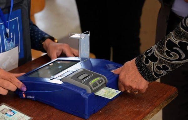 An Iraqi voter has her biometric voting card checked with her fingerprint upon arriving at a poll station in al-Hamdaniyah, some 30 kilometres from Mosul, on May 12, 2018. AFP file photo