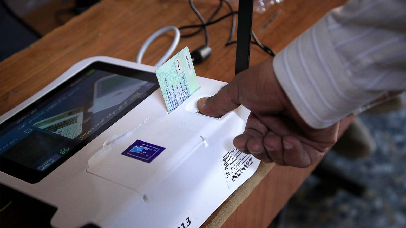 An Iraqi voter gives his fingerprint before voting in Baghdad in October 2021. AP file photo