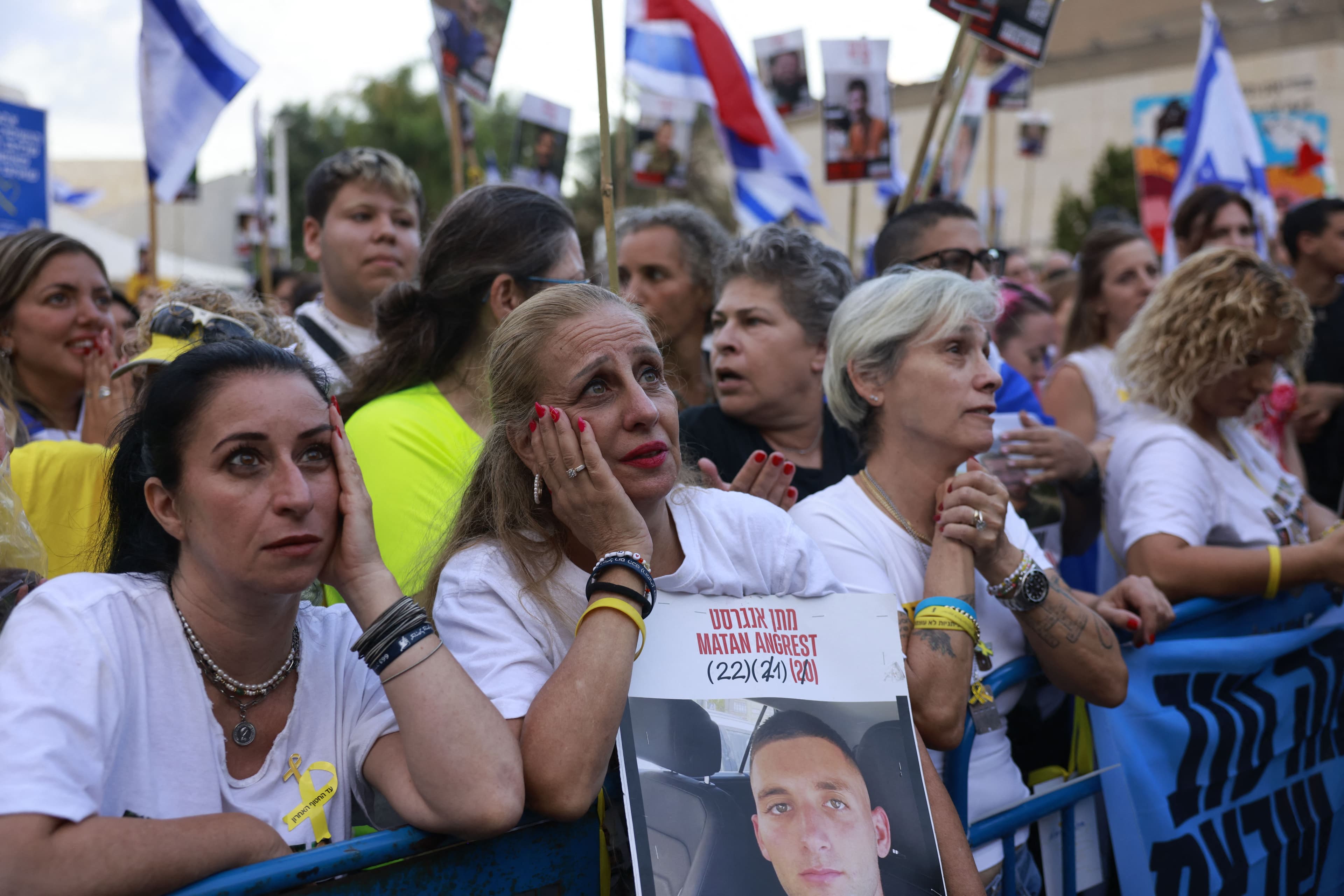 People holding up portraits of Israeli hostages, as they wait for their release at Hostage Square in Tel Aviv early on October 13, 2025. Photo: AFP