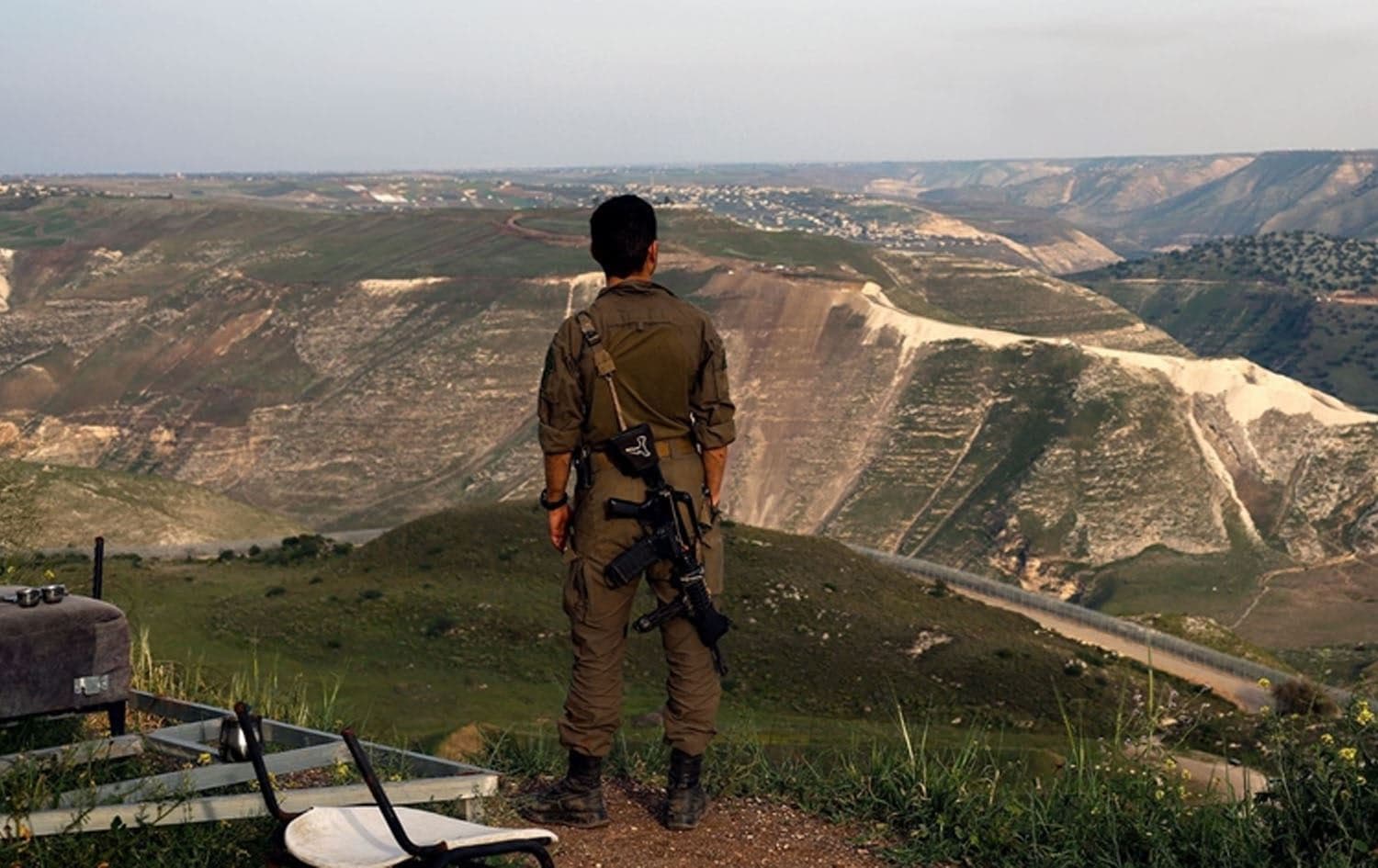 An Israeli soldier stands at a lookout point in the Israeli-annexed Golan Heights overlooking south Syria, March 25 2025. Photo: Jalaa Marey/AFP