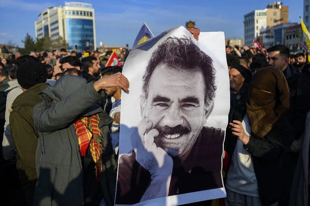 Supporters display a poster depicting jailed leader of the Kurdistan Workers' Party, Abdullah Ocalan, on 27 February 2025 in Istanbul. Photo: AFP