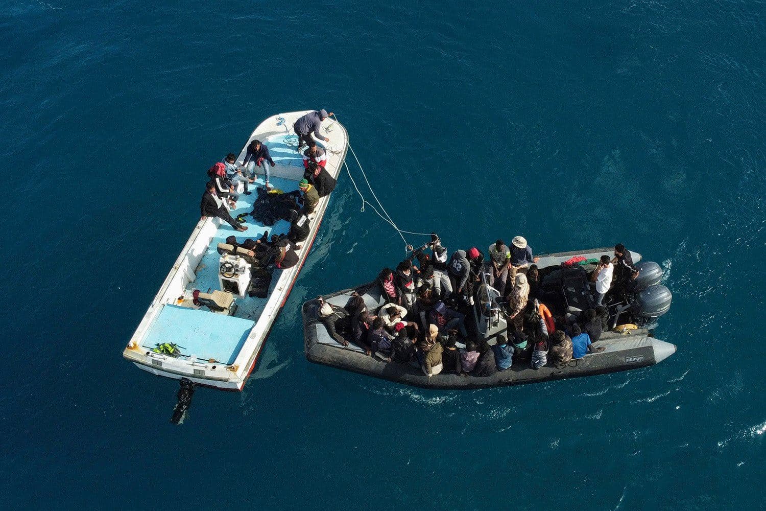 An aerial picture shows boats transporting migrants following their rescue at sea by the Libyan Coast Guard in April 2025. AFP file photo