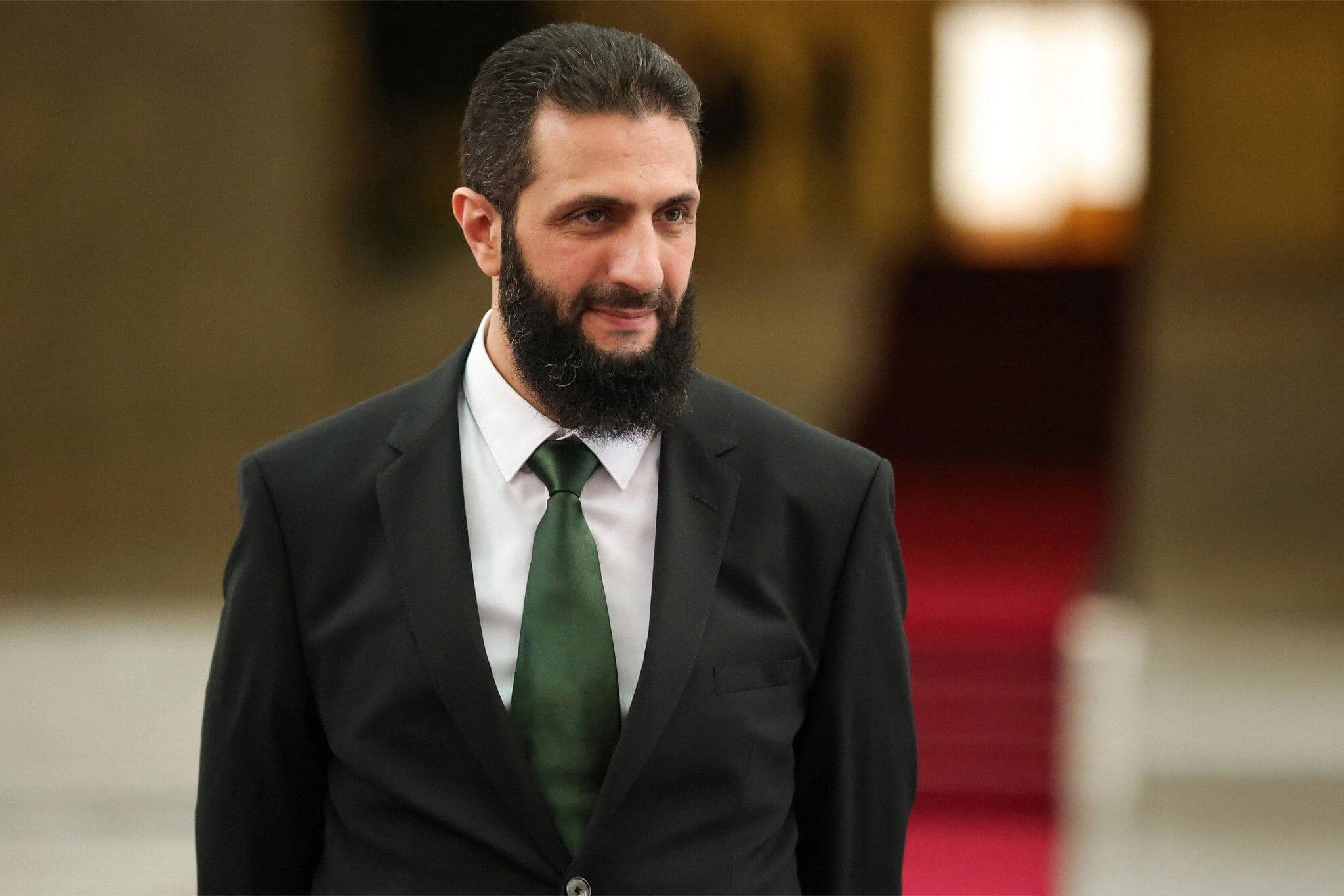 A handout picture released by Syria's transitional government shows the country's new leader Ahmed al-Sharaa waiting for the arrival of Spain's foreign minister at the presidential palace in Damascus on January 16, 2025.