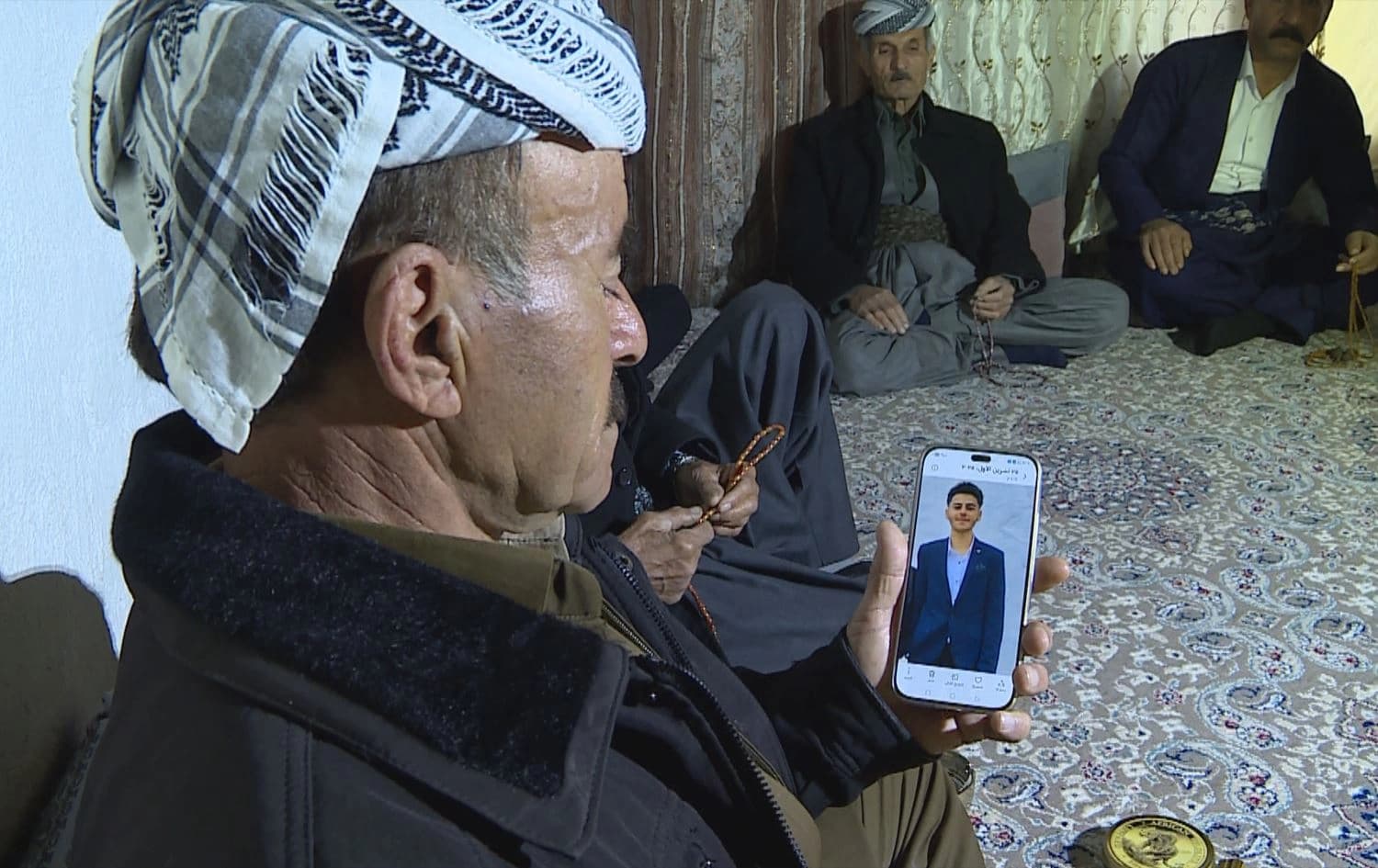 A Kurdish man in Erbil’s northeastern Bradost area showing a picture of his son on his phone to Rudaw in November 2025. Photo: screengrab/Rudaw
