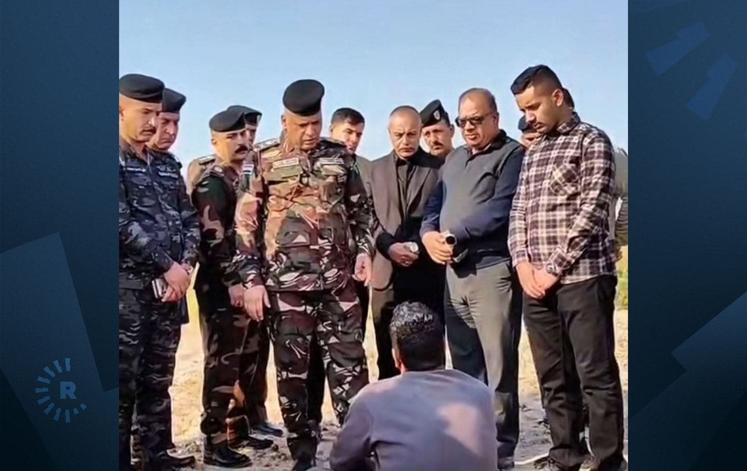 Security forces speak with man accused of killing wife in the southern Iraqi Diwaniyah province. Photo: Iraqi interior ministry/submitted  