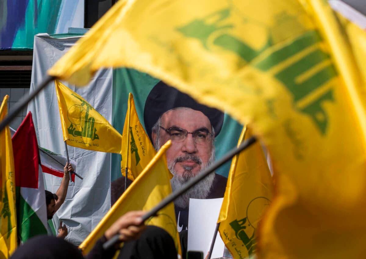 People wave Lebanese Hezbollah flags in front of a portrait of Secretary-General Hassan Nasrallah at a protest in Tehran condemning Israel’s military attack on Lebanon. AFP file photo