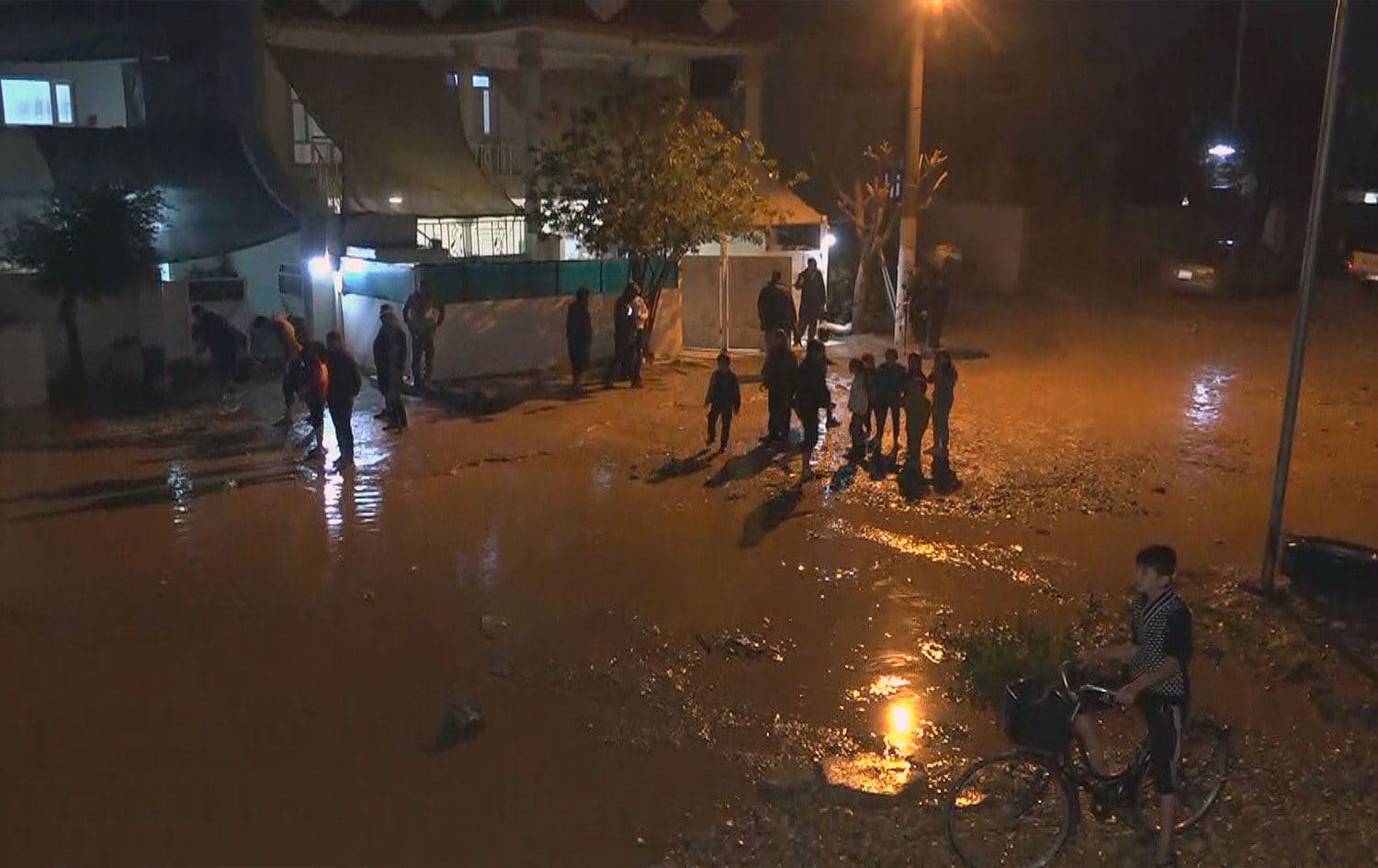 Residents stand outside their homes in a flooded neighborhood of Kalar, in the Garmiyan administration of Sulaimani province, on December 9, 2025. Photo: Screengrab/Rudaw