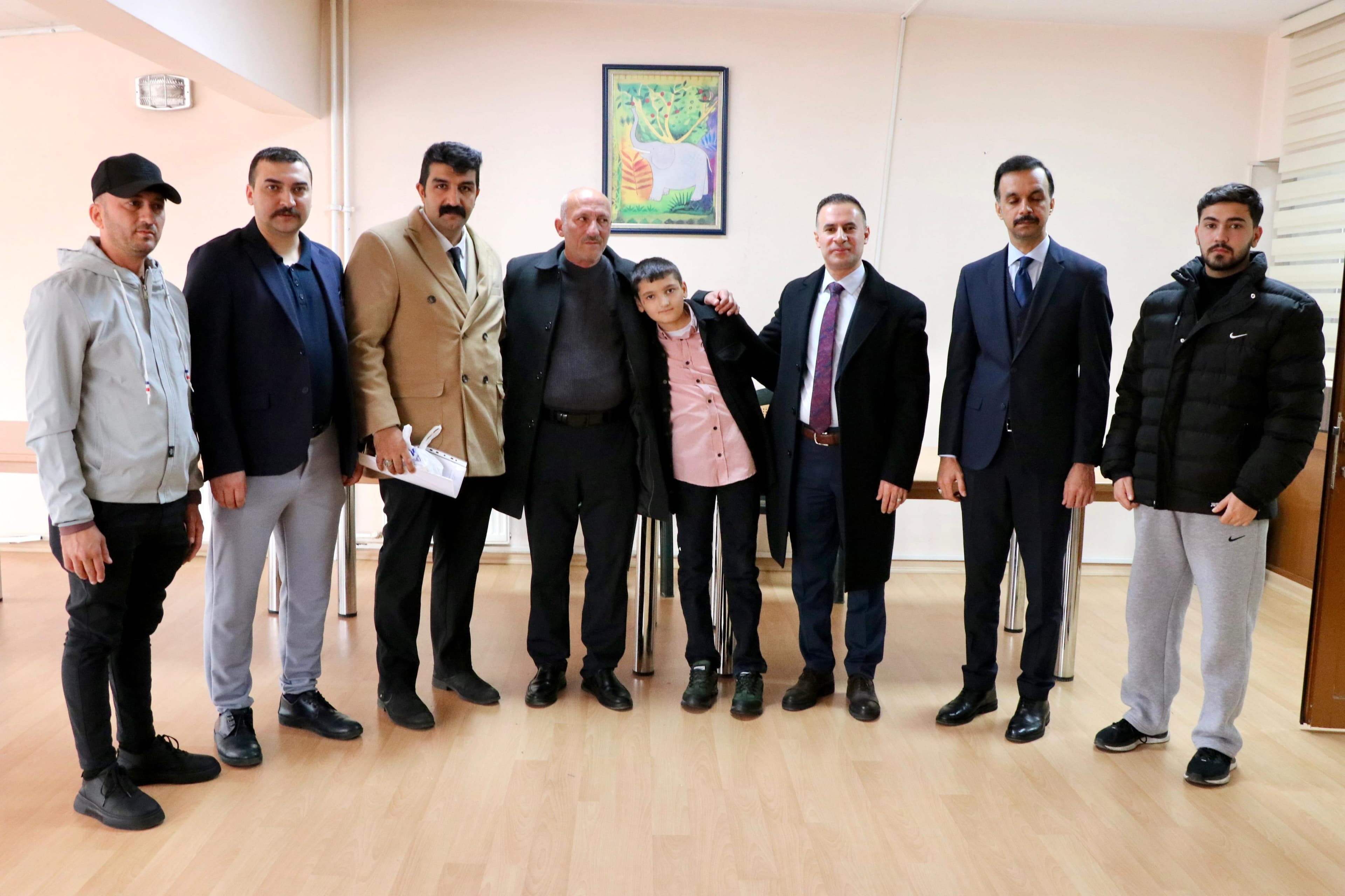 Ali Ghazi, a 12-year-old Iraqi boy, is pictured amomg relatives and staff from Iraq's diplomatic mission in Ankara. Photo: Iraqi embassy in Ankara.