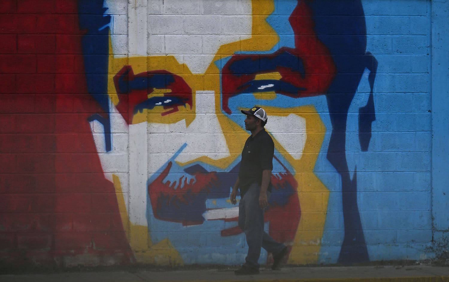 A man walking past a graffiti of Venezuelan President Nicolas Maduro in Caracas on January 3, 2026. Photo: Juan Barreto/AFP