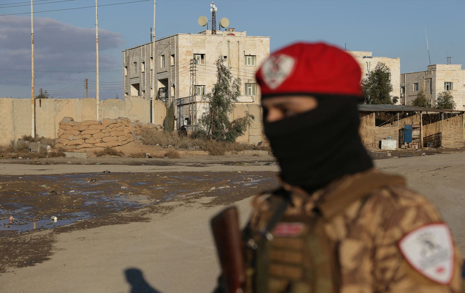 A Syrian government soldier stands outside SDF-controlled al-Aqtan prison on January 19, 2026. Photo: Bakr Alkasem / AFP