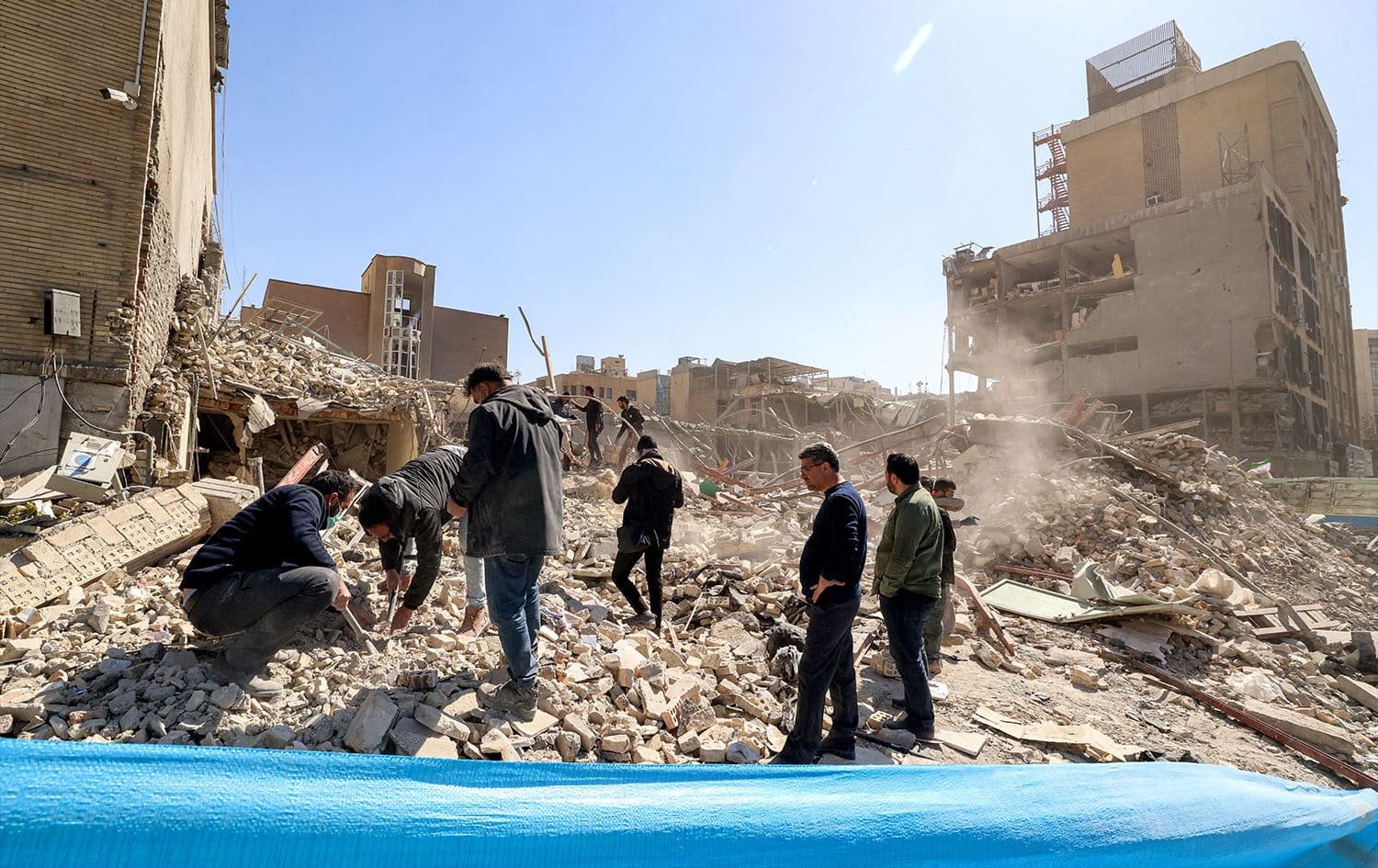 People inspect the rubble of a collapsed building near Ferdowsi square in Tehran on March 3, 2026. Photo: Atta Kenare / AFP