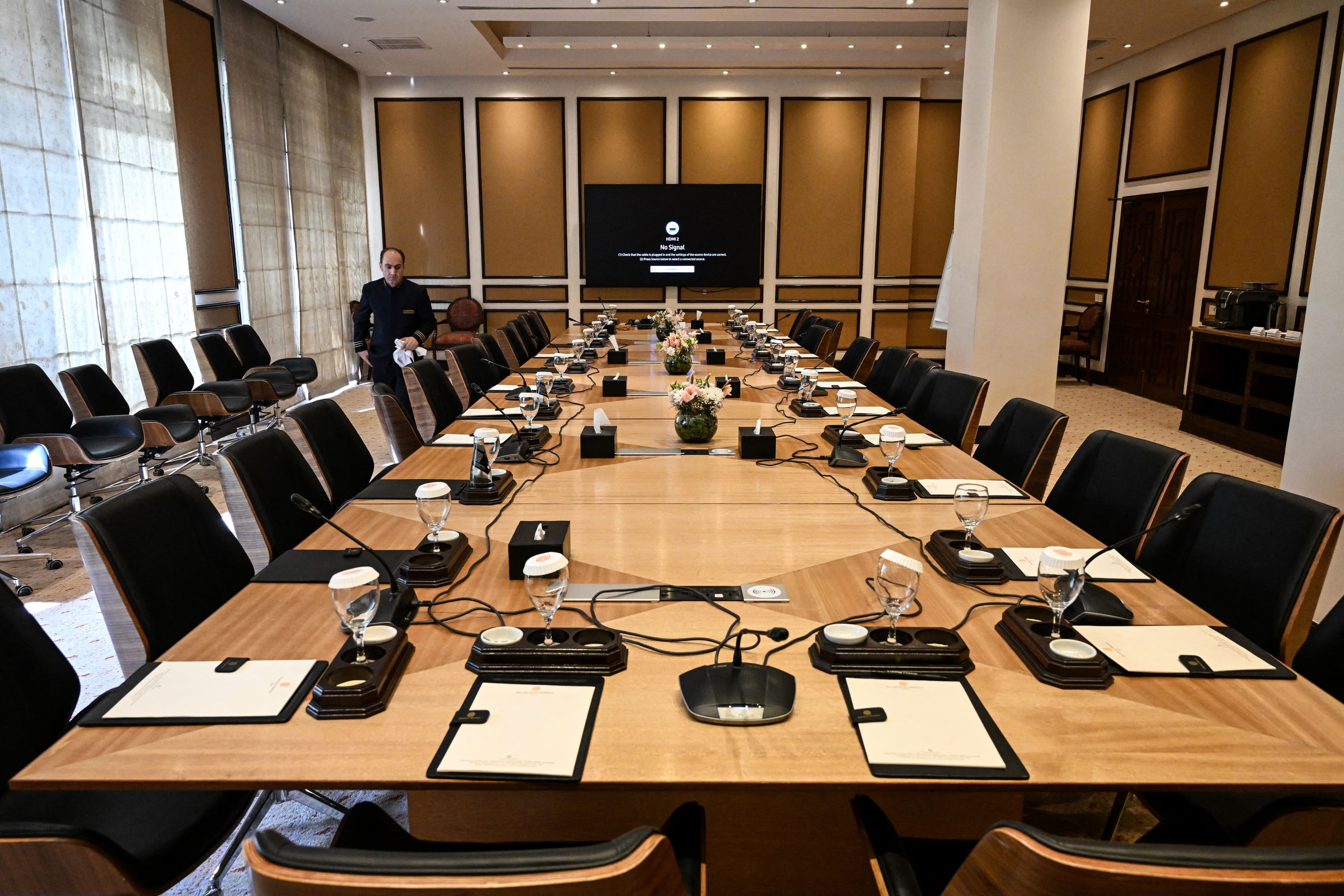 An employee arranges chairs in a meeting room at the Serena Hotel, the venue where Iran and the United States held peace talks earlier in Islamabad on April 15, 2026. Photo: AFP