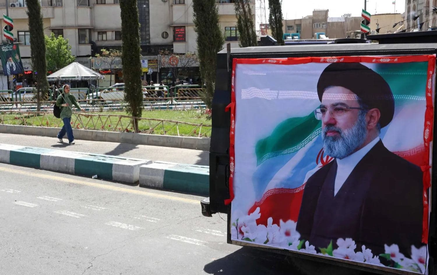 A woman walks past a banner depicting Iran's new supreme leader Mojtaba Khamenei, along a street in Tehran on April 5, 2026. Photo: AFP