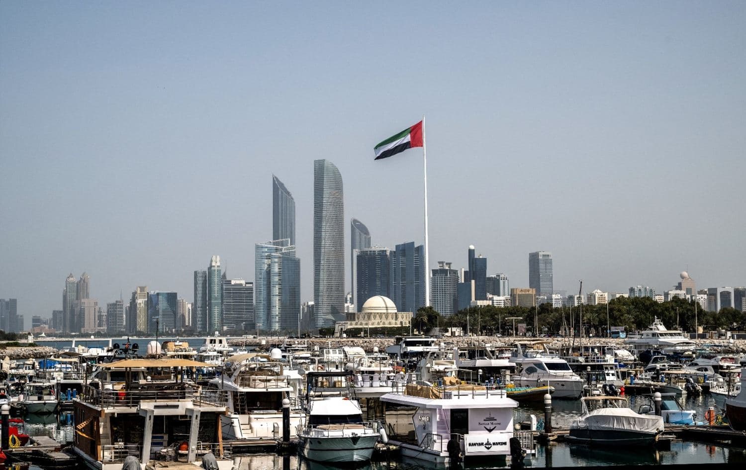 The United Arab Emirates flag flutters against the backdrop of the Abu Dhabi Skyline following a reported Iranian. Photo: AFP