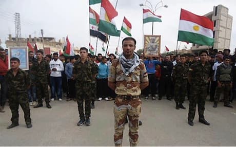 Members of a Kurdish fighting force trained in the Kurdistan Region march on the streets of Qamishli, August 2012. Photo: Welateme