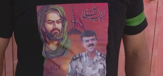 Kurdish young man wearing t-shirt with pictures of Imam Ali and fallen Peshmerga commander Hussein Mansour. Photo: Rudaw