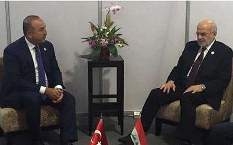 Ibrahim Jaafari (R) in a meeting with Turkish Foreign Minister Mevlut Cavusoglu on the sidelines ofmeetings at a summit of Cold War-era non-aligned countries in Venezuela