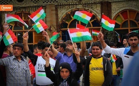 Kurds in Erbil wave the Kurdistan flag. Photo: Rudaw
