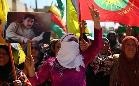 A Syrian Kurd carrying a picture of jailed Kurdish leader Abdullah Ocalan, the founder of the Kurdistan Workers' Party (PKK), takes part in a protest in the northeastern Syrian city of Qamishli this week, to denounce the Turkish raids on Kurdish positions in northeastern Syria. Photo: AFP/Delil Souleiman
