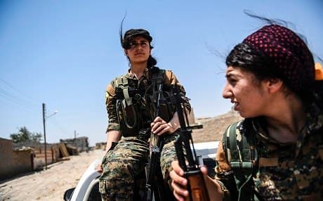 Members of the Women's Protection Units (YPJ) rest on the eastern outskirts of Raqqa on Tuesday, as part of the ongoing SDF offensive. Photo: Bulent Kilic | AFP