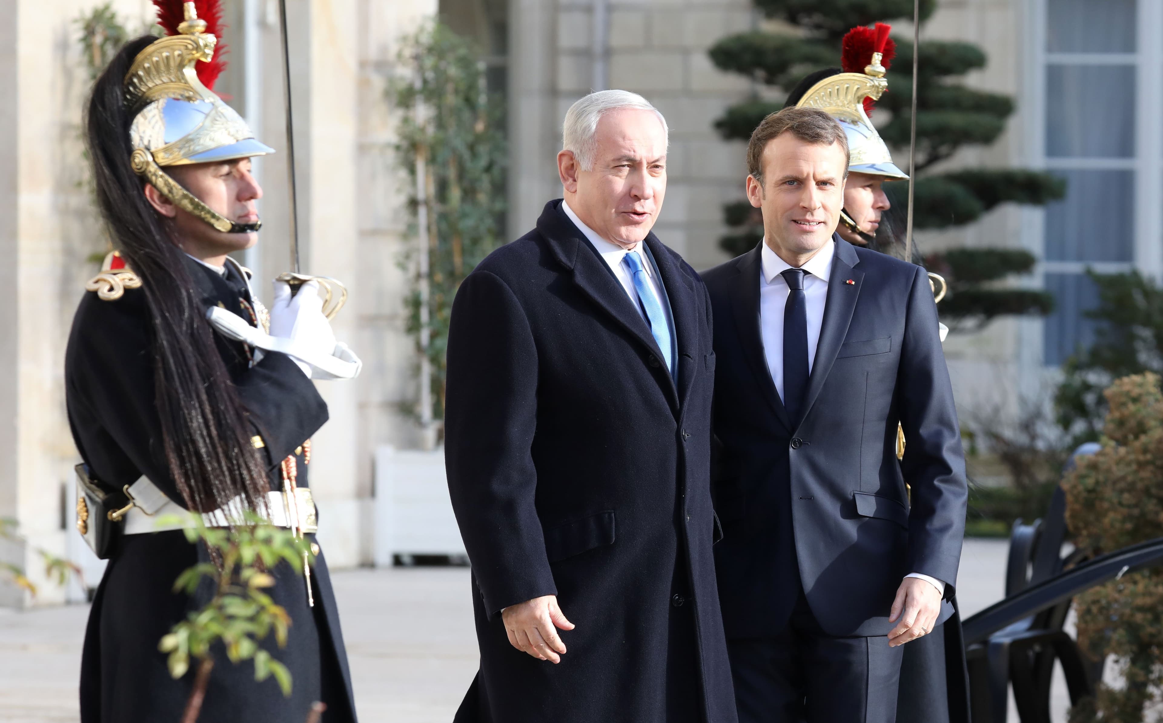 French President Emmanuel Macron (R) welcomes Israeli Prime Minister Benjamin Netanyahu in Paris on Sunday. Photo: Ludovic Marin/AFP