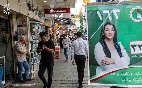 A PUK campaign poster featuring one of its female candidates hangs on a busy Sulaimani street. Photo: Sartip Othman/Rudaw
