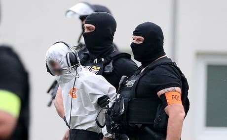 Police officers of a special unit escort Iraqi asylum seeker Ali Bashar, who is suspected of having killed a German teenage girl, to a helicopter in Wiesbaden, western Germany, on June 10, 2018, heading to a prison after Bashar testified. Photo: Hasan Bratic / dpa / AFP