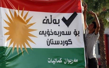 A man in Erbil hangs a banner that advocates for a 'Yes' vote in the Kurdistan Region's independence referendum that was held on September 25, 2017. File photo: Safin Hamed | AFP