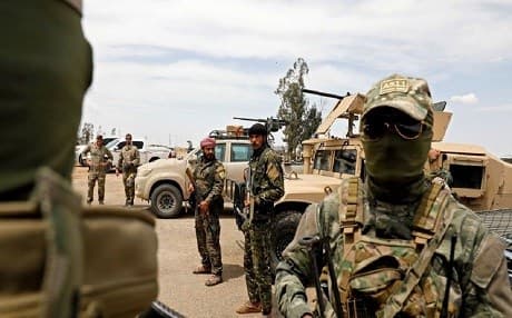 Syrian Democratic Forces (SDF) and US soldiers gather prior to launching a renewed military campaign against ISIS in Deir ez-Zor province, Syria, in May 2018. Photo: Delil Souleiman | AFP