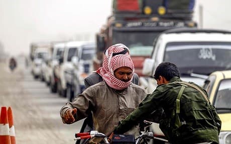 A member of the Raqqa security forces inspects people at a checkpoint. File photo: Delil Souleiman/AFP