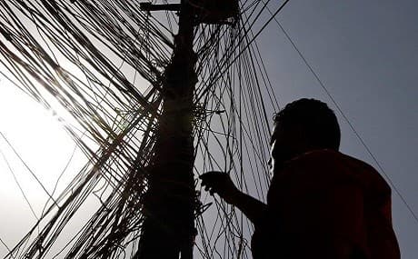An Iraqi man navigates a network of generator wires during a power outage in Baghdad, Iraq on June 25, 2010. File photo: Hadi Mizban / AP