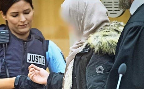 'Sabine Ulrike Sch.' is escorted by German officers during court proceedings in Stammheim, Germany, in May 2019. Photo: DPA/AFP