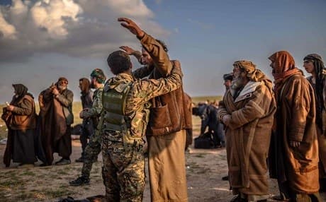 Suspected Islamic State fighters are searched after leaving the last ISIS holdout of Baghouz in Syria, on February 22 ,2019. Photo: AFP
