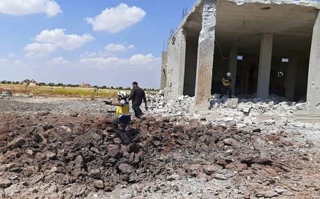 Civil Defense worker searches for victims under rubble after an airstrike in the town of Marret al-Numan, Idlib province on August 22, 2019. Photo: Syrian Civil Defense White Helmets via AP